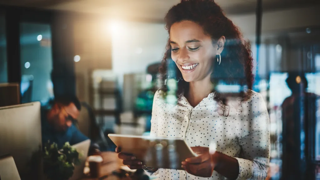 A digital tech executive reviewing a report on her tablet
