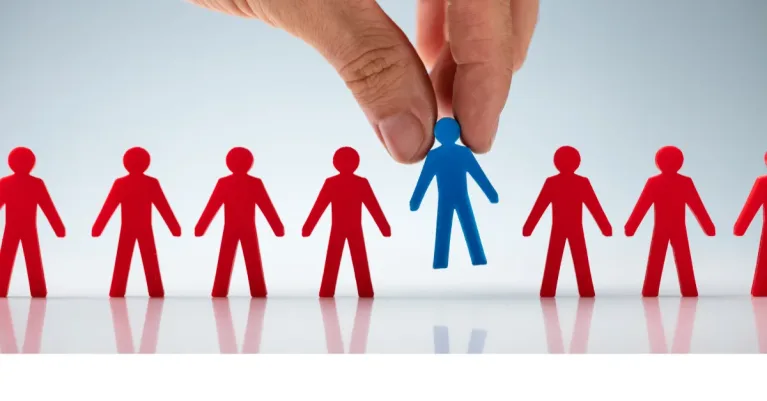 Hand selecting a blue icon among several red icons representing people